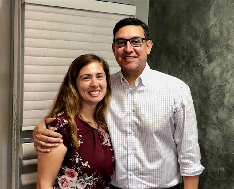 A couple posing for a photo together